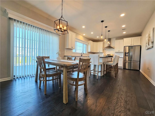 dining area with dark wood-type flooring, recessed lighting, and baseboards