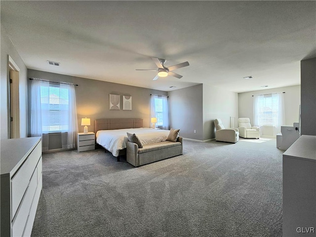 bedroom with a ceiling fan, carpet flooring, visible vents, and baseboards