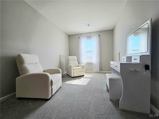 living area with visible vents, baseboards, and carpet flooring