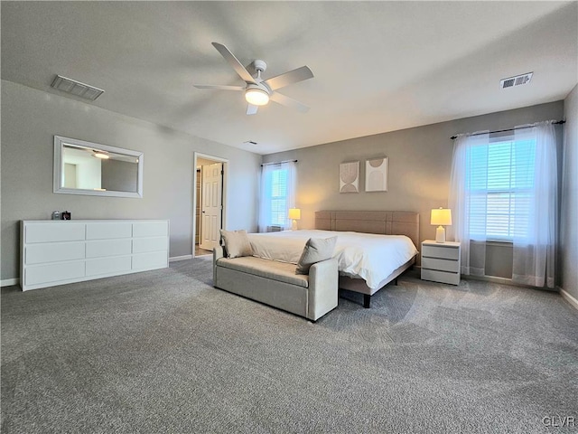 bedroom with carpet floors, visible vents, baseboards, and multiple windows