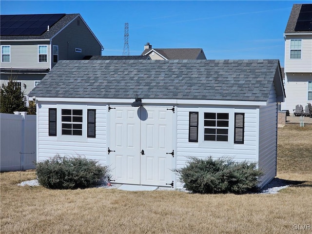 view of shed featuring fence