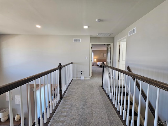 hallway featuring recessed lighting, carpet, visible vents, and an upstairs landing