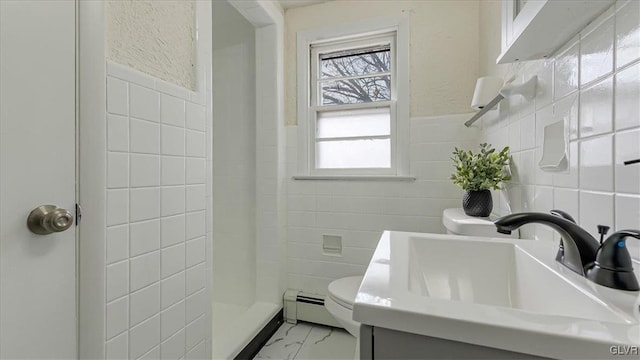 full bathroom featuring marble finish floor, tile walls, toilet, baseboard heating, and a sink