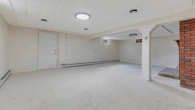 empty room featuring a baseboard heating unit and carpet floors