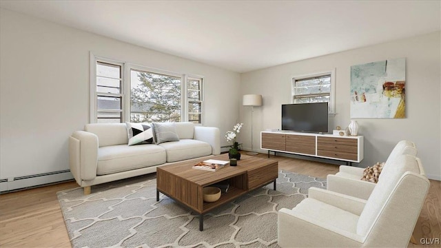 living room with a baseboard heating unit and wood finished floors