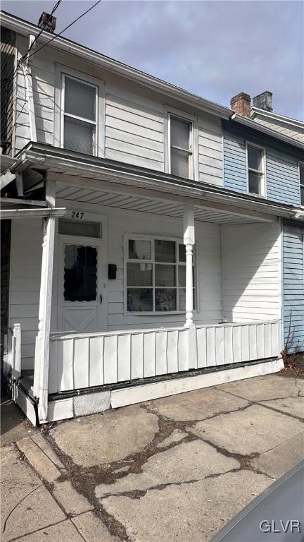 view of front of property featuring a porch and a chimney