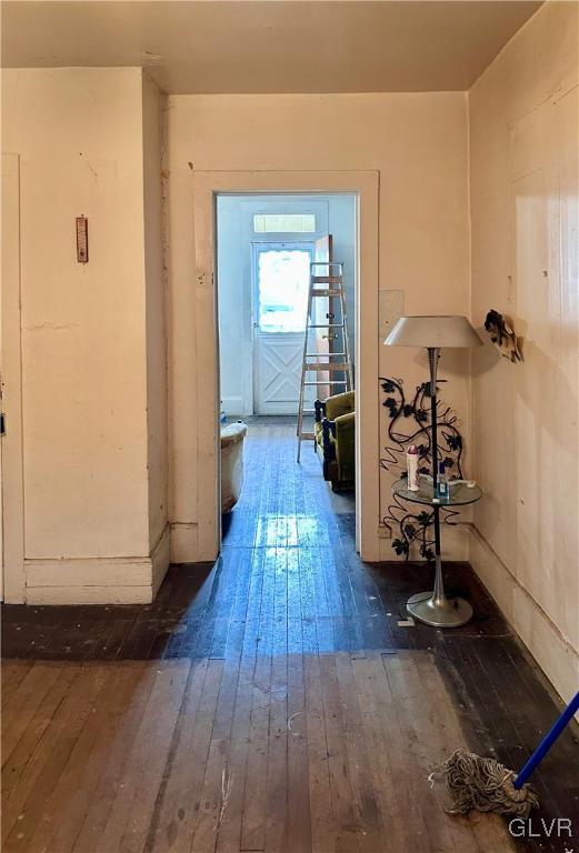 hallway with hardwood / wood-style flooring