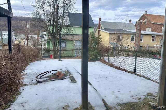 yard covered in snow featuring fence