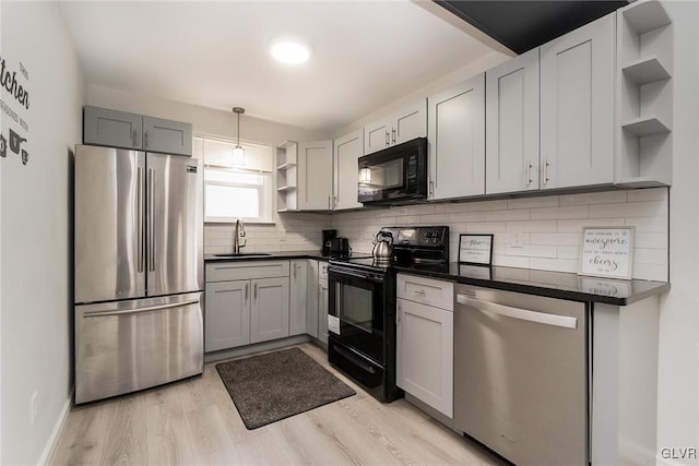 kitchen featuring tasteful backsplash, dark countertops, black appliances, open shelves, and a sink