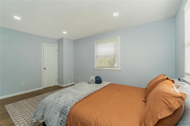 bedroom featuring baseboards, wood finished floors, and recessed lighting