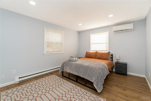 bedroom featuring recessed lighting, baseboard heating, an AC wall unit, wood finished floors, and baseboards