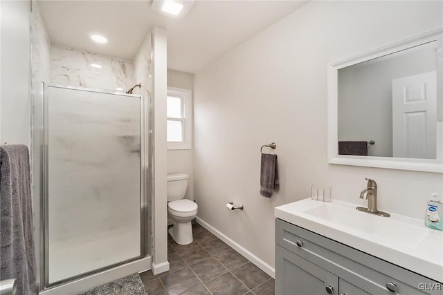 bathroom with toilet, vanity, baseboards, a shower stall, and tile patterned floors