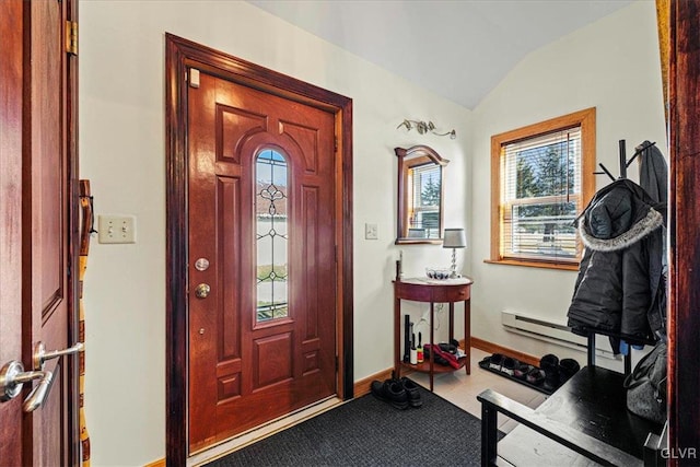 foyer entrance with lofted ceiling, baseboard heating, and baseboards