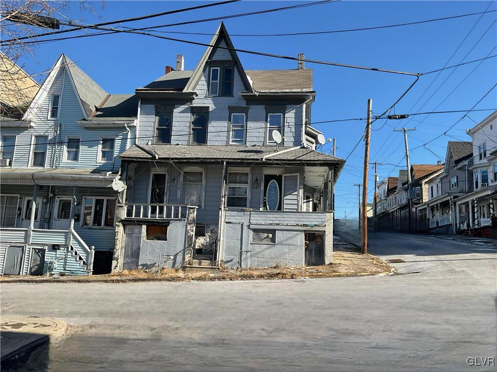 view of front of property with covered porch and a chimney