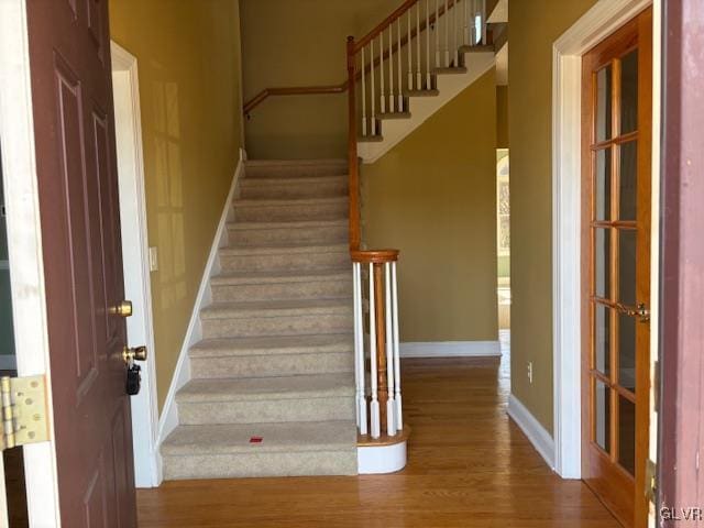 stairs featuring baseboards and wood finished floors