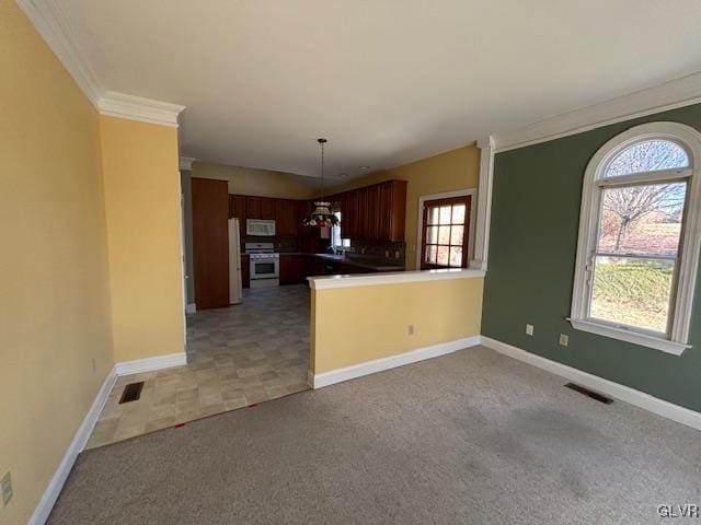 kitchen with visible vents, stainless steel gas stove, white microwave, and light carpet