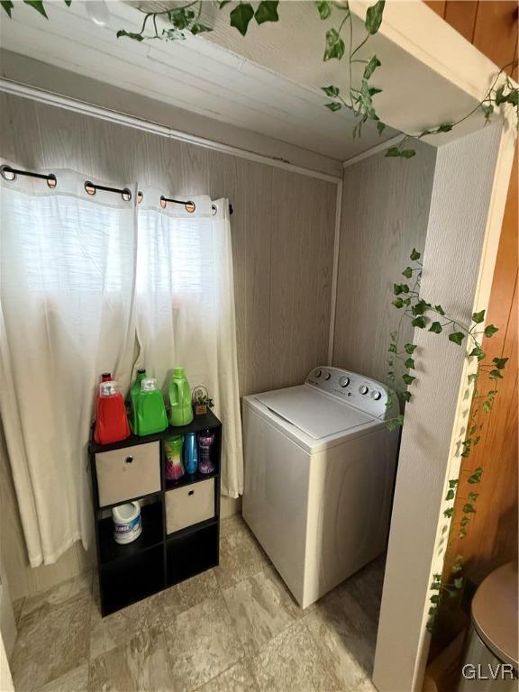 clothes washing area with washer / dryer