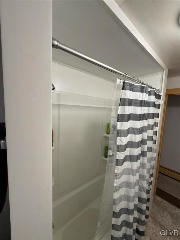 full bath featuring a shower with curtain and a baseboard radiator