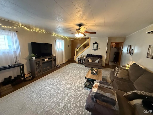 living room featuring stairs, ornamental molding, and a ceiling fan