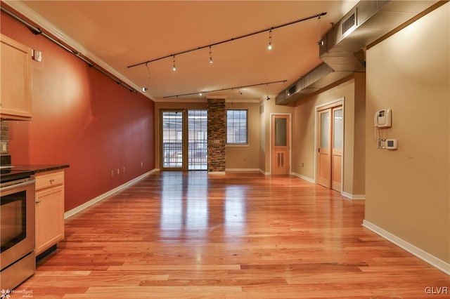 interior space featuring track lighting, light wood-type flooring, visible vents, and baseboards