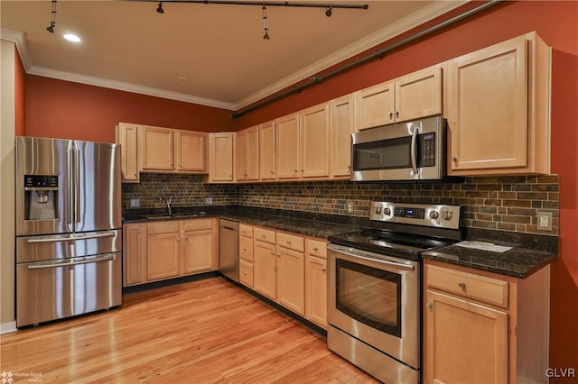 kitchen with light brown cabinets, appliances with stainless steel finishes, a sink, and ornamental molding