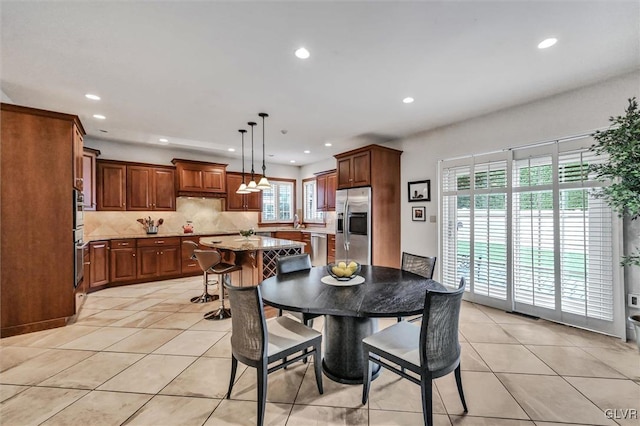 dining area with light tile patterned floors and recessed lighting