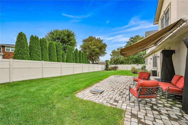 view of yard featuring a patio area and a fenced backyard