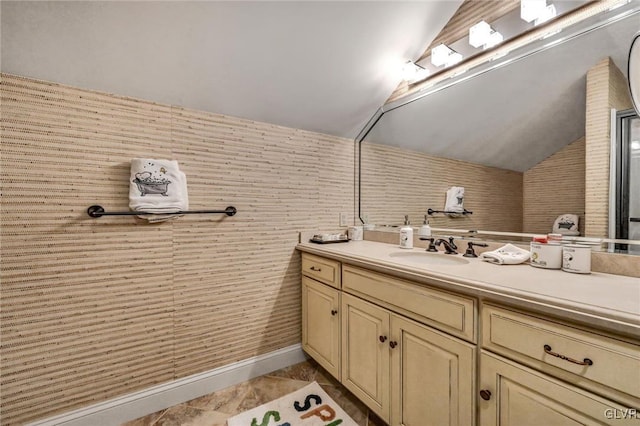 bathroom with vaulted ceiling and vanity