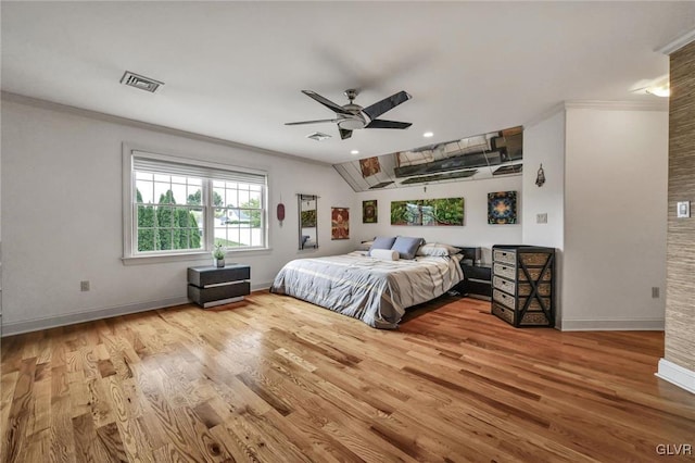 bedroom with wood finished floors, visible vents, and baseboards