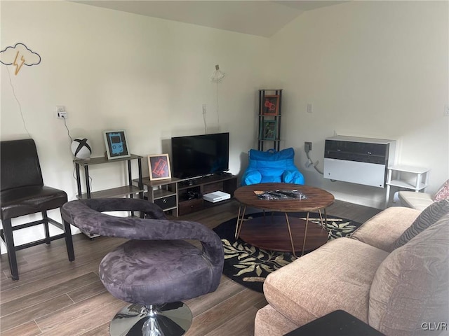 living room featuring vaulted ceiling and wood finished floors