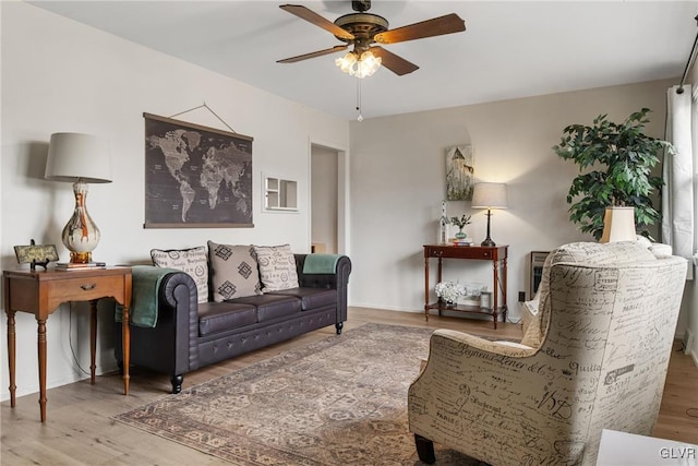 living room featuring a ceiling fan and wood finished floors