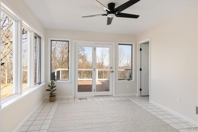 unfurnished sunroom with ceiling fan