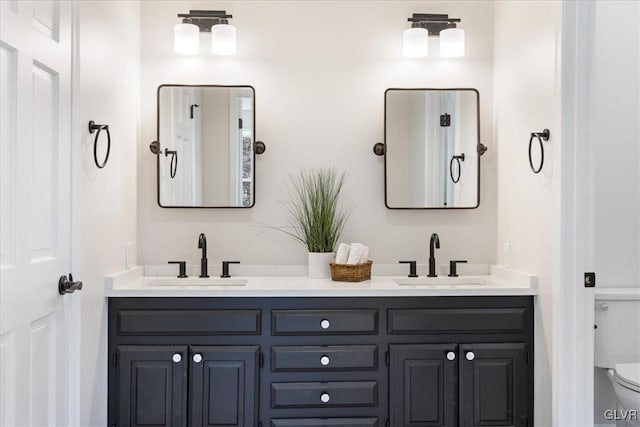 full bath featuring double vanity, toilet, and a sink