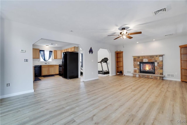 unfurnished living room featuring light wood-type flooring, baseboards, and visible vents