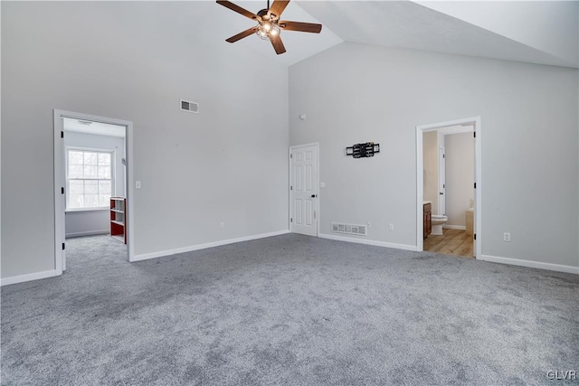 unfurnished living room featuring visible vents, a ceiling fan, carpet flooring, high vaulted ceiling, and baseboards