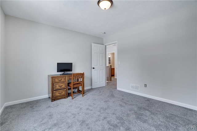 unfurnished office featuring carpet, visible vents, and baseboards