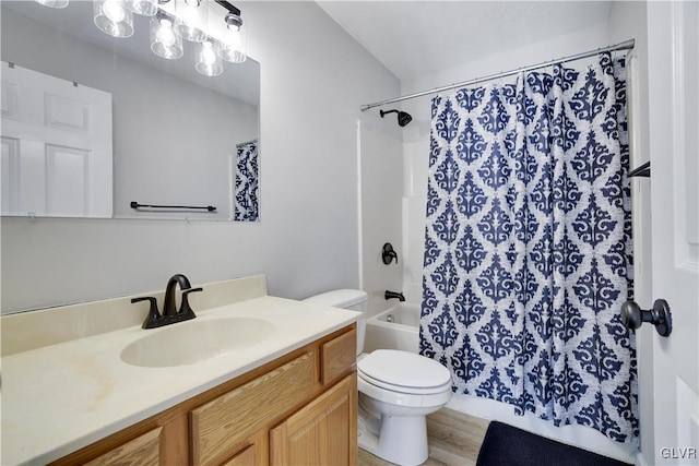 full bath featuring wood finished floors, shower / bath combo with shower curtain, vanity, and toilet