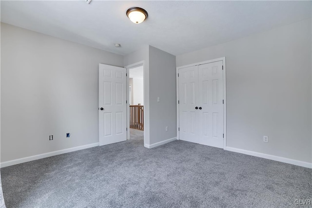 unfurnished bedroom featuring a closet, carpet flooring, and baseboards