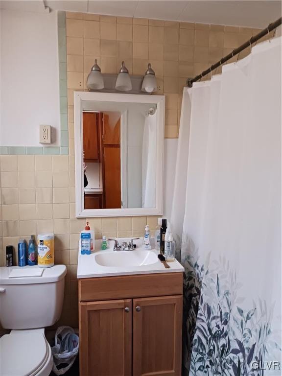 full bath featuring a shower with curtain, tile walls, toilet, and vanity