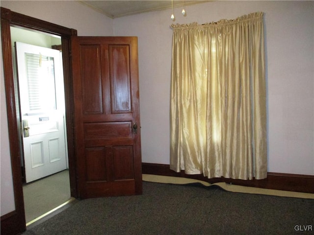 unfurnished bedroom with carpet floors and baseboards