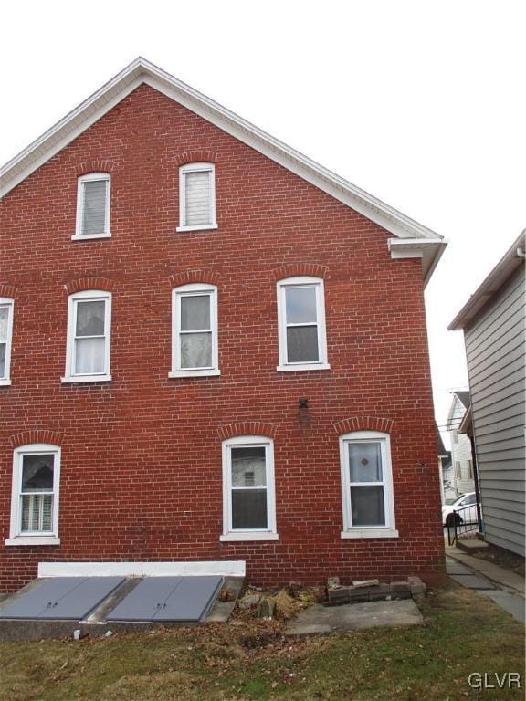 view of side of home with brick siding