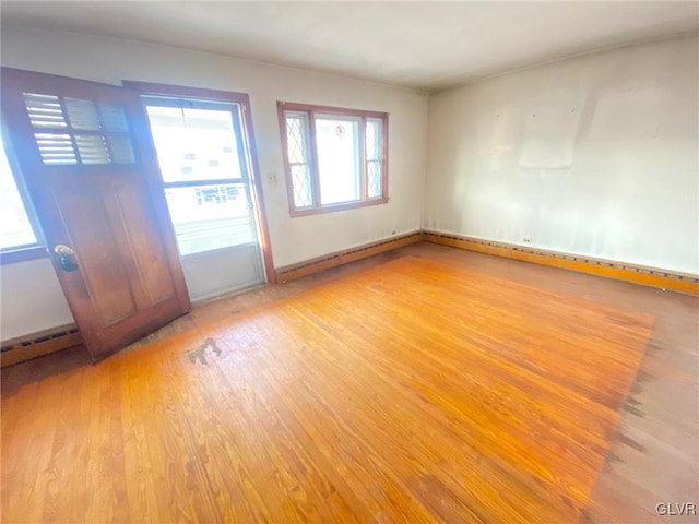 interior space featuring baseboard heating and wood finished floors