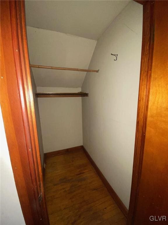 spacious closet featuring lofted ceiling and wood finished floors