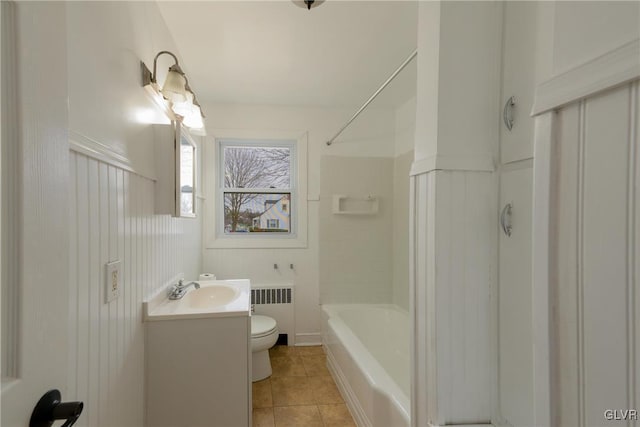 bathroom with shower / bathtub combination, toilet, vanity, tile patterned floors, and radiator