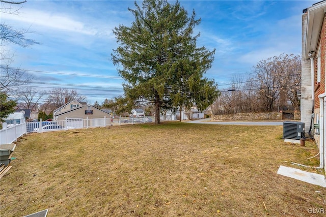 view of yard with fence and central AC