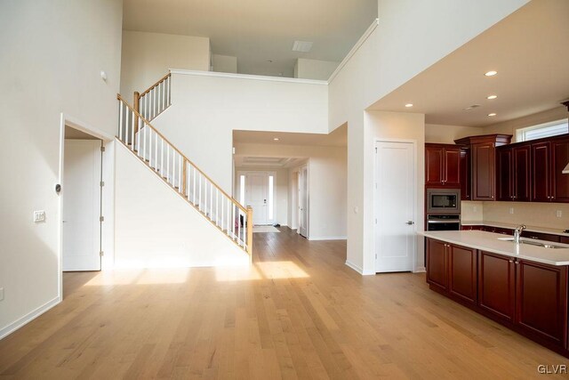 7013 Oak Ln, East Allen Twp, PA 18014 - kitchen with appliances with stainless steel finishes, reddish brown cabinets, a sink, light countertops, and light wood-style floors