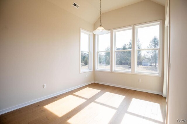 7013 Oak Ln, East Allen Twp, PA 18014 - unfurnished dining area with lofted ceiling, light wood finished floors, and baseboards