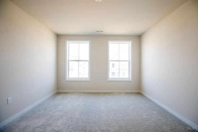 carpeted empty room with baseboards