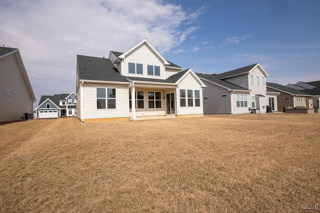 back of house with a lawn and cooling unit