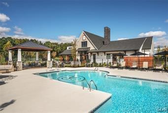 pool featuring a patio area, fence, and a gazebo